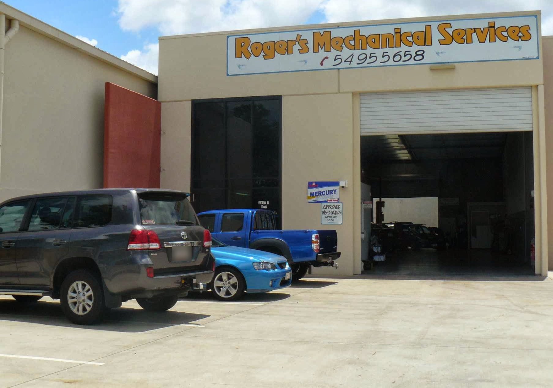 The Roger's Mechanical Services workshop on Boeing Place, Caboolture, with the roller door up and cars waiting out front